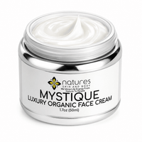 Thumbnail for An open silver jar of natures Skin and Body Mystique Luxury Organic Face Cream, showing the white cream inside, on a clean white background.